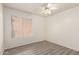 A standard bedroom with wood-look floors, a ceiling fan, and natural light at 6606 N 46Th Ave, Glendale, AZ 85301