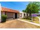 Charming home exterior with decorative tile roof, cozy front patio, and sign post on the right at 6606 N 46Th Ave, Glendale, AZ 85301