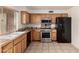 Well-equipped kitchen with stainless steel appliances, light wood cabinets, and granite countertops at 6606 N 46Th Ave, Glendale, AZ 85301