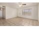 Light-filled living room features tile flooring, a ceiling fan, and a view to another room at 6606 N 46Th Ave, Glendale, AZ 85301