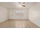 Inviting living room with tile flooring, ceiling fan, and a large window for plenty of natural light at 6606 N 46Th Ave, Glendale, AZ 85301