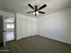 Spacious bedroom boasting plush carpet, a ceiling fan, and closet space at 740 W Dublin St, Gilbert, AZ 85233