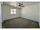 This bedroom boasts carpeting, a ceiling fan, and a bright window at 740 W Dublin St, Gilbert, AZ 85233