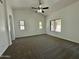 Large bedroom with carpeting and three windows and a ceiling fan at 740 W Dublin St, Gilbert, AZ 85233