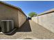 Side yard featuring desert landscaping, perimeter block wall, and an AC unit at 740 W Dublin St, Gilbert, AZ 85233