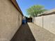 Side yard with desert landscaping, block perimeter wall and mature tree at 740 W Dublin St, Gilbert, AZ 85233