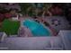 Aerial view of backyard with pool, fire pit, patio and lush desert landscaping at 8045 E Del Caverna Dr, Scottsdale, AZ 85258