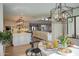 Bright breakfast nook area with hardwood floors, modern light fixture, and an open concept view of the kitchen at 8045 E Del Caverna Dr, Scottsdale, AZ 85258