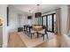 Elegant dining room features a modern light fixture, seating for eight, and backyard views at 8045 E Del Caverna Dr, Scottsdale, AZ 85258