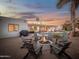 Backyard fire pit with seating, a pool, and covered patio in the background at 8045 E Del Caverna Dr, Scottsdale, AZ 85258