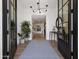 Bright foyer featuring hardwood floors, a stylish rug, chic decor, and views of the living space at 8045 E Del Caverna Dr, Scottsdale, AZ 85258