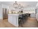 Bright, open kitchen features a large island with seating, modern appliances, and ample counter space at 8045 E Del Caverna Dr, Scottsdale, AZ 85258
