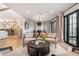 Open-concept living area with hardwood floors, neutral furniture, and large windows for natural light at 8045 E Del Caverna Dr, Scottsdale, AZ 85258