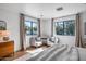 Bright main bedroom with modern decor, hardwood floors and a view of the backyard pool at 8045 E Del Caverna Dr, Scottsdale, AZ 85258