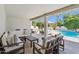 Covered patio with lounge furniture overlooking pool and lush backyard at 8045 E Del Caverna Dr, Scottsdale, AZ 85258