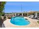 Inviting backyard pool with ample lounge seating and desert landscaping under a clear blue sky at 8045 E Del Caverna Dr, Scottsdale, AZ 85258