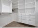 Organized walk-in closet with custom shelving and drawer storage at 8045 E Del Caverna Dr, Scottsdale, AZ 85258