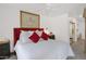 Bright main bedroom offers ample space with a striking red headboard and large picture window at 8651 E Royal Palm Rd # 121, Scottsdale, AZ 85258