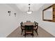 Traditional dining room with tray ceiling, chandelier, and wainscoting at 8651 E Royal Palm Rd # 121, Scottsdale, AZ 85258