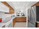 Bright kitchen features tile flooring, stainless steel refrigerator, and ample cabinet space at 8651 E Royal Palm Rd # 121, Scottsdale, AZ 85258
