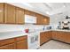 Bright kitchen offers a white electric range, ample cabinetry, and tile flooring at 8651 E Royal Palm Rd # 121, Scottsdale, AZ 85258