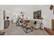 Spacious living room features a partial kitchen view, stylish furnishings, and ample natural light at 8651 E Royal Palm Rd # 121, Scottsdale, AZ 85258