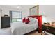 Comfortable main bedroom is complete with a large window, dresser, and a cozy bed at 8651 E Royal Palm Rd # 121, Scottsdale, AZ 85258