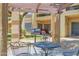 Charming patio with stone and gravel ground covering, outdoor seating, and grill for summer barbeques at 8651 E Royal Palm Rd # 121, Scottsdale, AZ 85258
