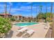 Enjoy the community swimming pool with lounge chairs and palm trees at 8651 E Royal Palm Rd # 121, Scottsdale, AZ 85258