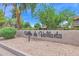 Exterior view of Villa de Vallarta community signage on a sunny day at 8651 E Royal Palm Rd # 121, Scottsdale, AZ 85258