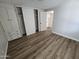 Bedroom offering a large closet, wood-style floors, and entry to the kitchen at 918 S Evangeline Ave, Mesa, AZ 85208