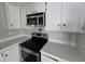 Modern kitchen featuring stainless steel appliances, white cabinetry, and spacious countertops at 918 S Evangeline Ave, Mesa, AZ 85208
