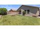 Spacious backyard featuring a lush lawn, a fire pit area, and desert landscaping at 9329 E Olla Ave, Mesa, AZ 85212
