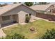 The backyard has a fire pit, patio area, desert landscaping, and block fence at 9329 E Olla Ave, Mesa, AZ 85212