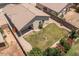 Aerial view of backyard with a fire pit, green lawn, and desert landscaping at 9329 E Olla Ave, Mesa, AZ 85212