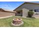 Beautiful backyard featuring a firepit and privacy landscaping, creating an oasis for outdoor living at 9329 E Olla Ave, Mesa, AZ 85212