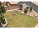 View of large green backyard, with a decorative fire pit, patio, and lush landscaping at 9329 E Olla Ave, Mesa, AZ 85212