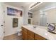 Bathroom featuring a large mirror, wooden cabinets, and tiled floors at 9329 E Olla Ave, Mesa, AZ 85212