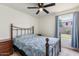 Comfortable bedroom with a ceiling fan and a large window with outside view at 9329 E Olla Ave, Mesa, AZ 85212