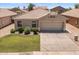 Attractive home with a tile roof, well-maintained lawn, desert landscaping and a two-car garage at 9329 E Olla Ave, Mesa, AZ 85212