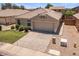 Beautiful home with a tile roof, a manicured lawn, desert landscaping, and a two-car garage at 9329 E Olla Ave, Mesa, AZ 85212