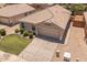 Charming home with a tile roof, manicured lawn, desert landscaping and an attached two-car garage at 9329 E Olla Ave, Mesa, AZ 85212