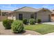 Charming single-story home featuring a neutral color palette, well-manicured lawn, and tidy landscaping at 9329 E Olla Ave, Mesa, AZ 85212