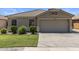 Attractive single-story home boasts a well-kept lawn, a paved driveway, and desert landscaping at 9329 E Olla Ave, Mesa, AZ 85212