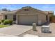 Inviting single-story home featuring a tidy front yard, a wide driveway, and desert landscaping at 9329 E Olla Ave, Mesa, AZ 85212