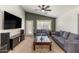 Cozy living room with a ceiling fan, vaulted ceilings, and neutral wall color and carpet at 9329 E Olla Ave, Mesa, AZ 85212