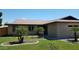 Charming single-story home featuring a well-manicured lawn and desert-friendly landscaping at 1009 E Hampton Ave, Mesa, AZ 85204