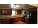Updated kitchen featuring granite countertops, stainless steel appliances, and wood cabinets at 1009 E Hampton Ave, Mesa, AZ 85204
