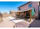 Backyard featuring a covered patio with seating area, desert landscaping and block wall at 1017 W Lydia Ln, Phoenix, AZ 85041