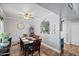 Cozy dining room features hardwood floors, ceiling fan, and pass-through to kitchen at 1017 W Lydia Ln, Phoenix, AZ 85041